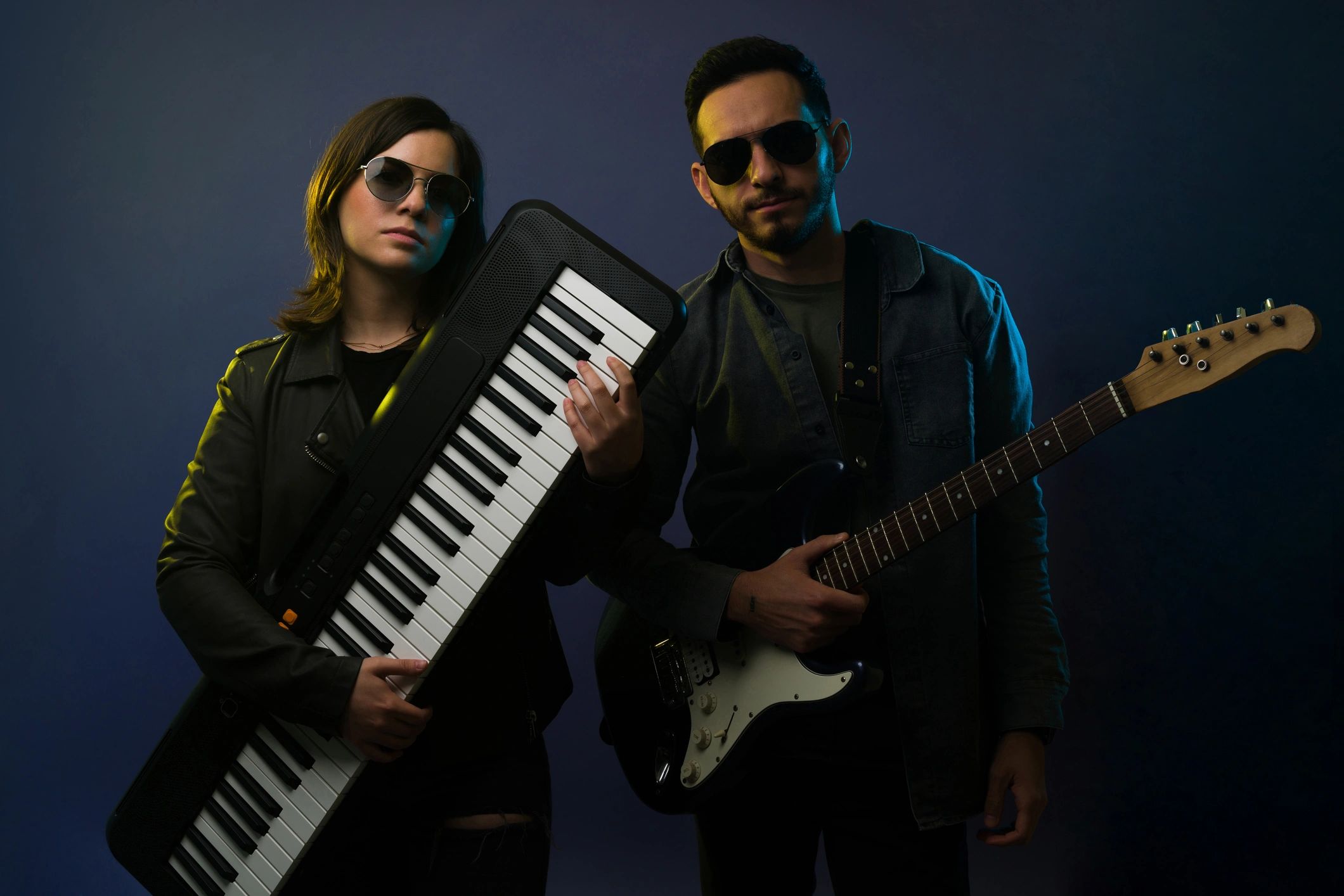 Artistic rock star showing her keyboard and young